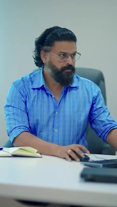Still from the video: an Arbrit Safety team member working at a desk in the office